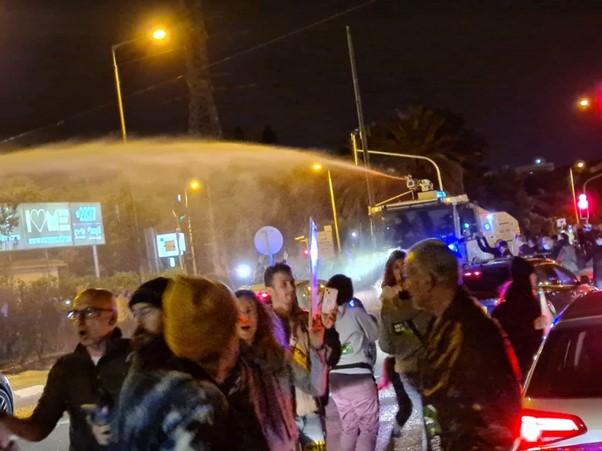 A big demonstration in Raanana, by PM Naftali Bennet’s private residence. The Police is trying to disperse the demonstration by using water cannon.  Photo by Moran Hanan
